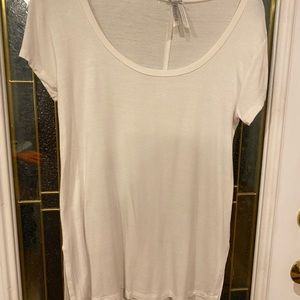 White Scoop-necked blouse with deep side slits for easy movement.